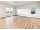 Spacious living room with beautiful wood floors, and bright sunny windows at 19058 E 94Th Pl, Commerce City, CO 80022