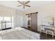 Main bedroom with wood floors and barn door at 16058 E Geddes Ln # 26, Aurora, CO 80016