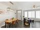 Open concept dining area with contemporary light fixture and seating for four at 16058 E Geddes Ln # 26, Aurora, CO 80016