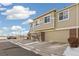 Townhouse exterior with a two-car garage and landscaping at 16058 E Geddes Ln # 26, Aurora, CO 80016