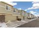 Row of townhouses with attached garages and landscaping at 16058 E Geddes Ln # 26, Aurora, CO 80016