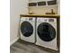 Modern laundry room with stacked washer and dryer at 16058 E Geddes Ln # 26, Aurora, CO 80016