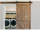 Laundry room with washer, dryer, and barn door at 16058 E Geddes Ln # 26, Aurora, CO 80016