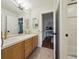 Bright bathroom featuring double sinks, tiled floors, and an open doorway to another room at 20363 E Top T Ranch Pl, Parker, CO 80134