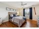 Comfortable bedroom featuring hardwood floors, a ceiling fan, and natural light at 20363 E Top T Ranch Pl, Parker, CO 80134