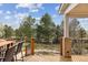 Spacious deck with outdoor seating, wood railings, and views of a professionally landscaped yard at 20363 E Top T Ranch Pl, Parker, CO 80134
