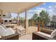 Covered deck with comfortable outdoor seating, stylish wood railings, and scenic views at 20363 E Top T Ranch Pl, Parker, CO 80134