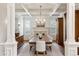 Elegant dining room with coffered ceiling, hardwood floors, fireplace, and custom shutters bringing sophistication to the space at 20363 E Top T Ranch Pl, Parker, CO 80134