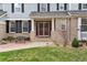 Inviting entrance with a cozy bench, meticulous landscaping, and a red screen door adding character to the brick facade at 20363 E Top T Ranch Pl, Parker, CO 80134