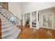 Stunning foyer boasting hardwood floors, a staircase with wrought iron accents, and elegant pillars enhancing the open layout at 20363 E Top T Ranch Pl, Parker, CO 80134