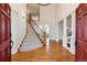 Grand foyer featuring hardwood floors, a staircase with iron railings, and elegant columns creating an open and airy feel at 20363 E Top T Ranch Pl, Parker, CO 80134