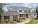 Stately two-story home featuring a brick and gray facade, complemented by mature landscaping and a welcoming walkway at 20363 E Top T Ranch Pl, Parker, CO 80134