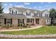 Charming two-story home featuring a brick and gray facade, complemented by mature landscaping and a welcoming walkway at 20363 E Top T Ranch Pl, Parker, CO 80134