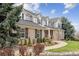 Elegant home showcasing a meticulously maintained lawn, complemented by gray siding, brick accents, and a welcoming front porch at 20363 E Top T Ranch Pl, Parker, CO 80134