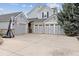 Spacious three-car garage with driveway and basketball hoop, offering ample parking at 20363 E Top T Ranch Pl, Parker, CO 80134