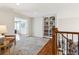 Hallway with hardwood floors, built-in bookshelves, and staircase at 20363 E Top T Ranch Pl, Parker, CO 80134