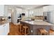 Kitchen island featuring granite countertops, seating, and a cooktop at 20363 E Top T Ranch Pl, Parker, CO 80134