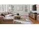 Bright living room with hardwood floors, neutral tones, and plantation shutters at 20363 E Top T Ranch Pl, Parker, CO 80134