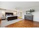 Spacious main bedroom suite with hardwood floors, a large bed, and an en-suite bathroom at 20363 E Top T Ranch Pl, Parker, CO 80134