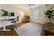 Well-lit home office with hardwood floors, a ceiling fan, dual monitors, and a large area rug at 20363 E Top T Ranch Pl, Parker, CO 80134