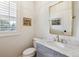 Elegant powder room with marble countertop, gold fixtures, and stylish mirror at 20363 E Top T Ranch Pl, Parker, CO 80134