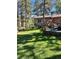 Landscaped backyard with deck and seating area at 26347 De Berry St, Conifer, CO 80433