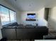 Spacious living room with sectional sofa and large TV at 503 S Rollie Ave # 12A, Fort Lupton, CO 80621