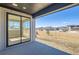 Covered back porch with sliding glass doors offering views of the yard and neighborhood at 3109 Newfound Lake Rd, Berthoud, CO 80513