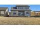 Exterior view of backyard featuring gray home with modern siding and a large grass area at 3109 Newfound Lake Rd, Berthoud, CO 80513