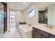 Modern bathroom with dual sinks, soaking tub, and large shower with dark accents at 3109 Newfound Lake Rd, Berthoud, CO 80513