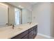 Bathroom featuring dual sinks, long vanity, and a large mirror over modern cabinets at 3109 Newfound Lake Rd, Berthoud, CO 80513