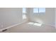 Well-lit bedroom featuring carpeted floors, base molding and natural light through two windows at 3109 Newfound Lake Rd, Berthoud, CO 80513