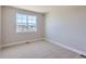 A bright bedroom with carpeted floors and a large window offering natural light at 3109 Newfound Lake Rd, Berthoud, CO 80513