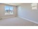 A bright bedroom features neutral carpet and two large windows for plenty of natural light at 3109 Newfound Lake Rd, Berthoud, CO 80513