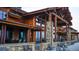 Stunning clubhouse exterior featuring timber construction, stone accents, and outdoor seating at 3109 Newfound Lake Rd, Berthoud, CO 80513