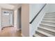 Bright foyer with hardwood floors, staircase, and view of the front door at 3109 Newfound Lake Rd, Berthoud, CO 80513