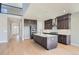 Modern kitchen with dark cabinetry, a large island, stainless steel appliances, and hardwood floors at 3109 Newfound Lake Rd, Berthoud, CO 80513