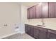 Functional laundry room boasts modern cabinets, a countertop, and ample storage space at 3109 Newfound Lake Rd, Berthoud, CO 80513