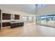 Bright open-concept space with hardwood flooring, modern kitchen, and sliding glass doors at 3109 Newfound Lake Rd, Berthoud, CO 80513