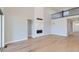 Spacious living room featuring a stone fireplace, hardwood floors, and ample natural light at 3109 Newfound Lake Rd, Berthoud, CO 80513