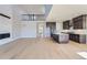 Expansive living area with a stone fireplace, hardwood floors, and open layout to the kitchen at 3109 Newfound Lake Rd, Berthoud, CO 80513