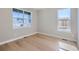 Empty room with hardwood flooring and large windows letting in natural light at 3109 Newfound Lake Rd, Berthoud, CO 80513