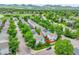 An aerial view of the property nestled in a neighborhood with lush greenery and mountain views in the distance at 11803 W Tufts Pl, Morrison, CO 80465