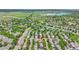 Aerial view showing property's location in a verdant neighborhood with a lake visible in the distance at 11803 W Tufts Pl, Morrison, CO 80465