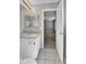 Bathroom featuring tiled floors, a toilet, vanity and a view into the bedroom, for functionality and style at 11803 W Tufts Pl, Morrison, CO 80465