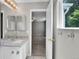 Stylish bathroom offering neutral paint, vanity, and a view into the bedroom, merging functionality with modern design at 11803 W Tufts Pl, Morrison, CO 80465