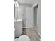 This bathroom has a toilet, vanity, and wood-look floors at 11803 W Tufts Pl, Morrison, CO 80465