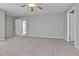 Large bedroom showcasing neutral paint, plush carpeting, a ceiling fan, and multiple entryways at 11803 W Tufts Pl, Morrison, CO 80465