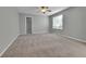 Spacious bedroom featuring plush carpet, neutral paint, and a ceiling fan, perfect for a relaxing retreat at 11803 W Tufts Pl, Morrison, CO 80465
