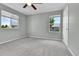 This bedroom has neutral walls, carpet, fan, and natural light at 11803 W Tufts Pl, Morrison, CO 80465